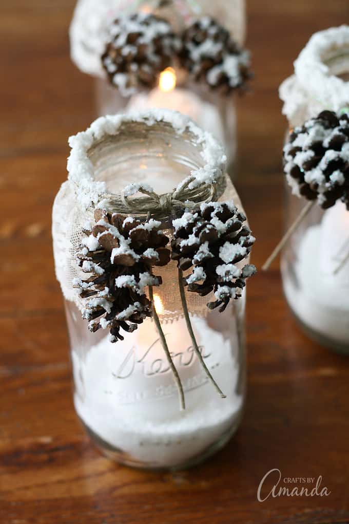 candle jars decorated with pine cones by craftsbyamanda